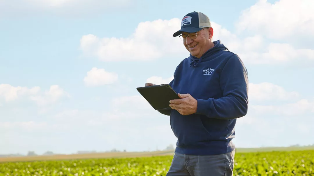 Farmer in field with an iPad