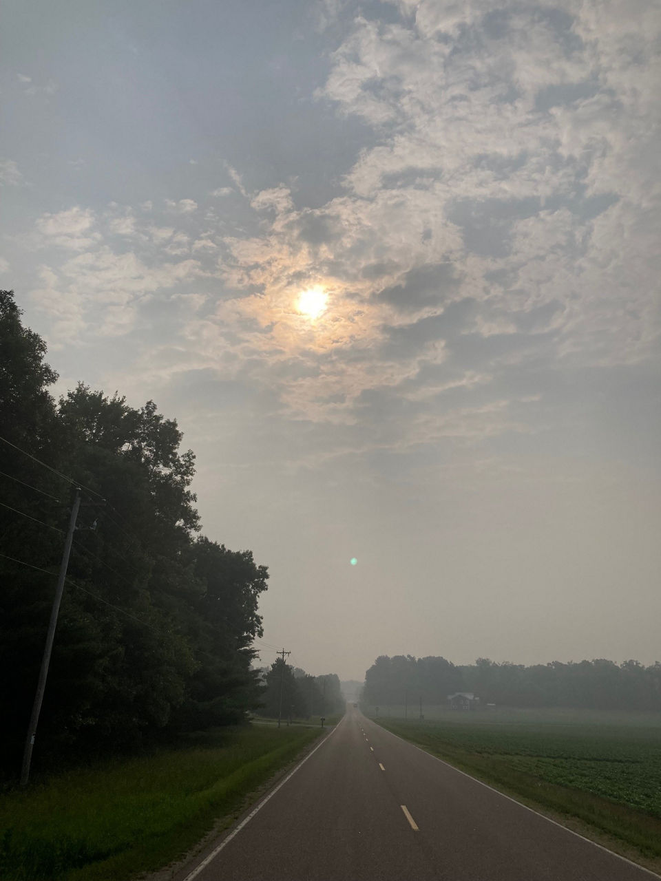 Canadian wildfire smoke appears like a dense fog in this picture of Pine River, Wisconsin.