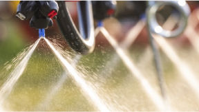 Closeup of sprayer nozzles spraying a chemical 