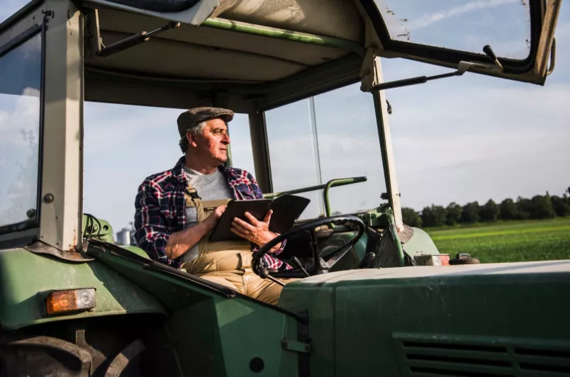 European Farmer using iPad in Tractor Cab