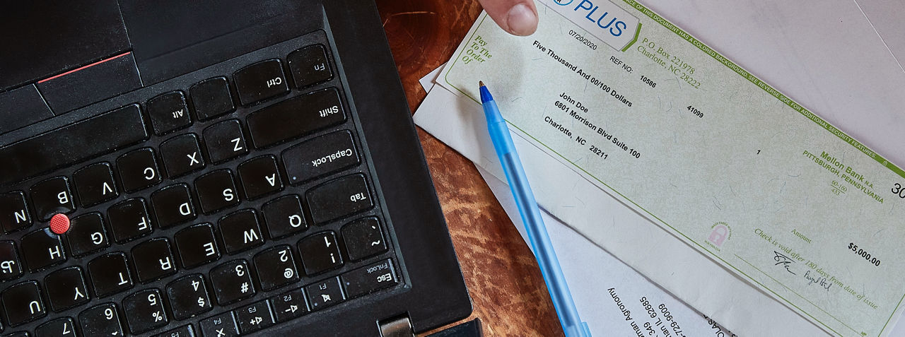 Image of a farmer's laptop and the reward they received from the Bayer PLUS Program.