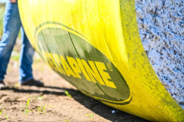 Close-up of a Deltapine® branded wrapped cotton bale during harvest