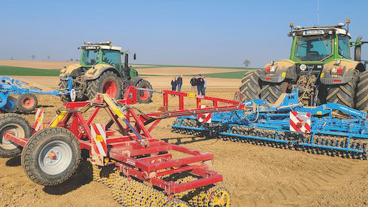 Tractors with harvesting equipment in a field