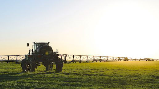 Fungicide sprayer working in the field on a sunny day