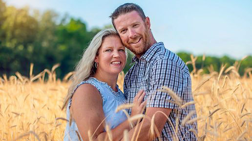 Jenn and David VanDeVelde facing the camera in the field