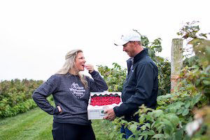 Jenn and David VanDeVelde picking and tasting berries